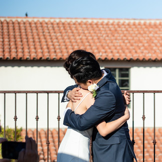 Bride and groom embrace  on Mercado San Augustin rooftop