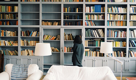 Student browsing books in a college library representing Tiger Crest Educational Consulting’s standalone core services focused on academic and admissions readiness.