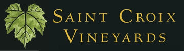 Saint Croix Vineyards Logo, gold lettering with a green grape leaf on a a black background