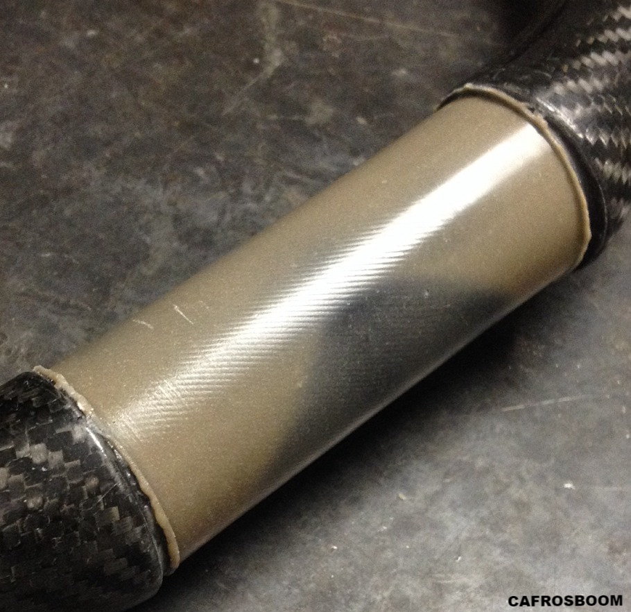 Repair of a worn carbon windsurfing boom at the clamp area using an exceptionally hard mineral filled epoxy compound.