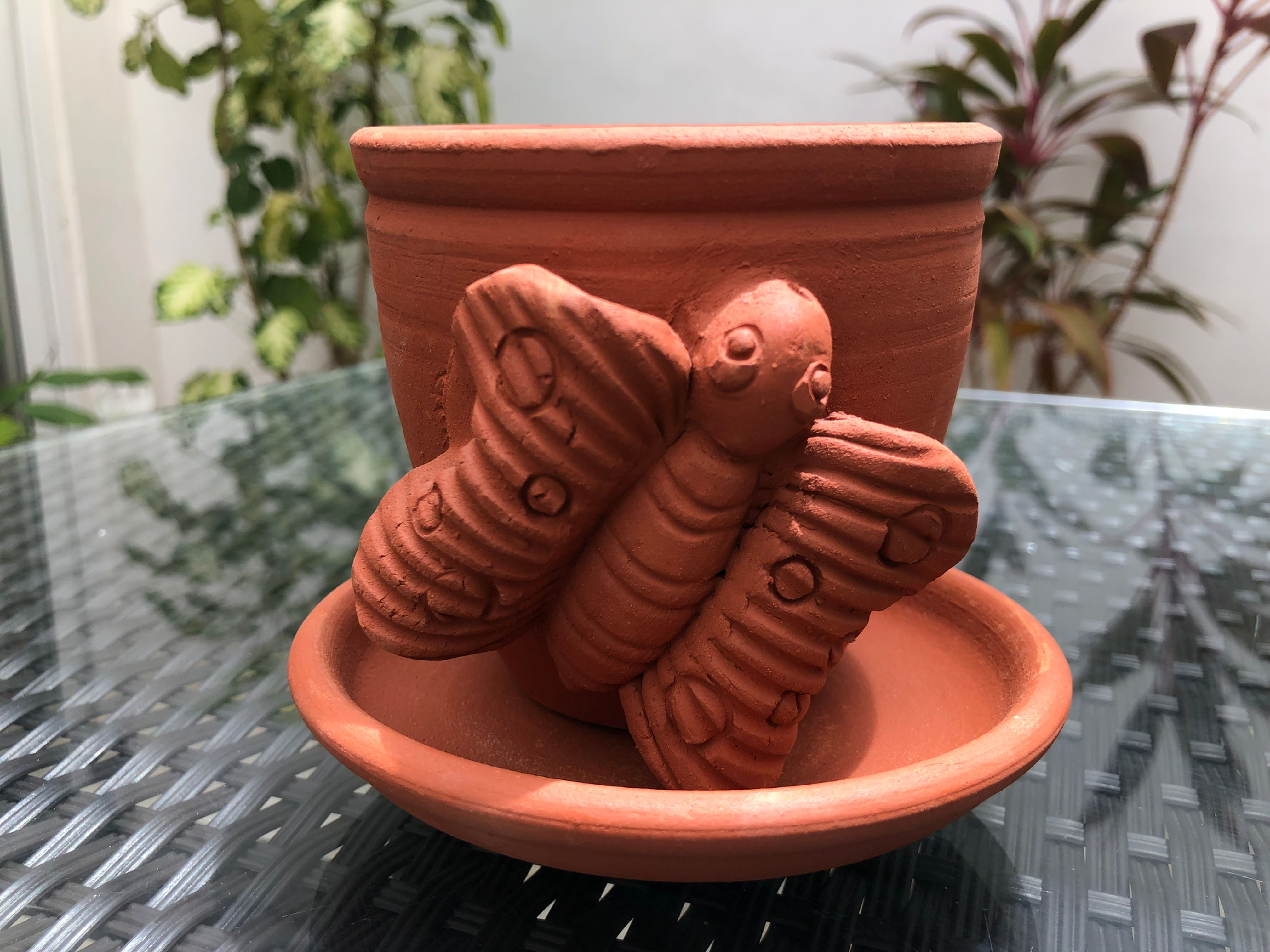 Terracotta planter butterfly