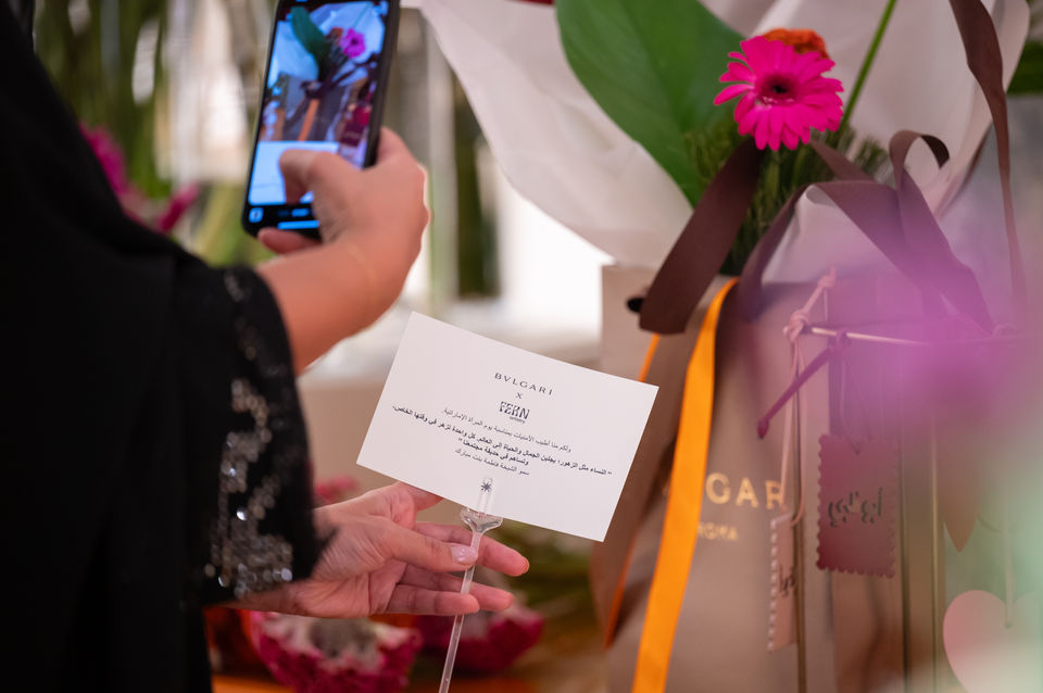 Guest taking a photo of Bvlgari gift at Dubai event