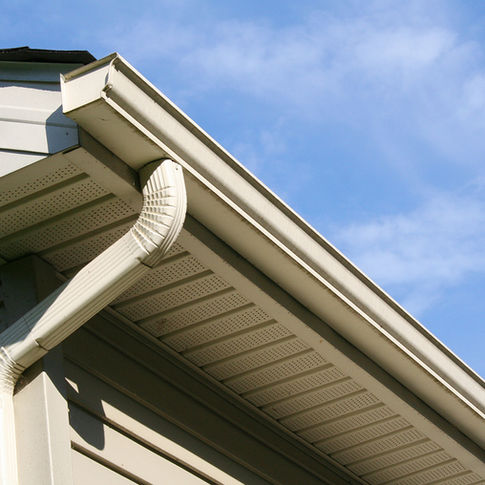 White metal gutter installation on a home