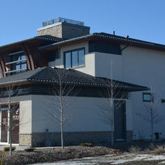 Side exterior view of a residential building with concrete walls