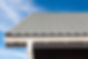 White aluminum eavestrough installed on the roof of a home