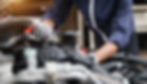 A mechanic performing maintenance on a car