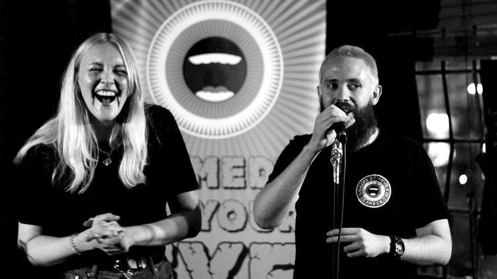 Couple of comedians speaking to people on a date at a comedy show