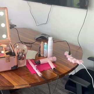 Professional commercial hair and makeup artist prepping talent on set for a network television.