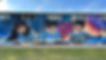 Custom graffiti mural on a playground wall of students.jpg