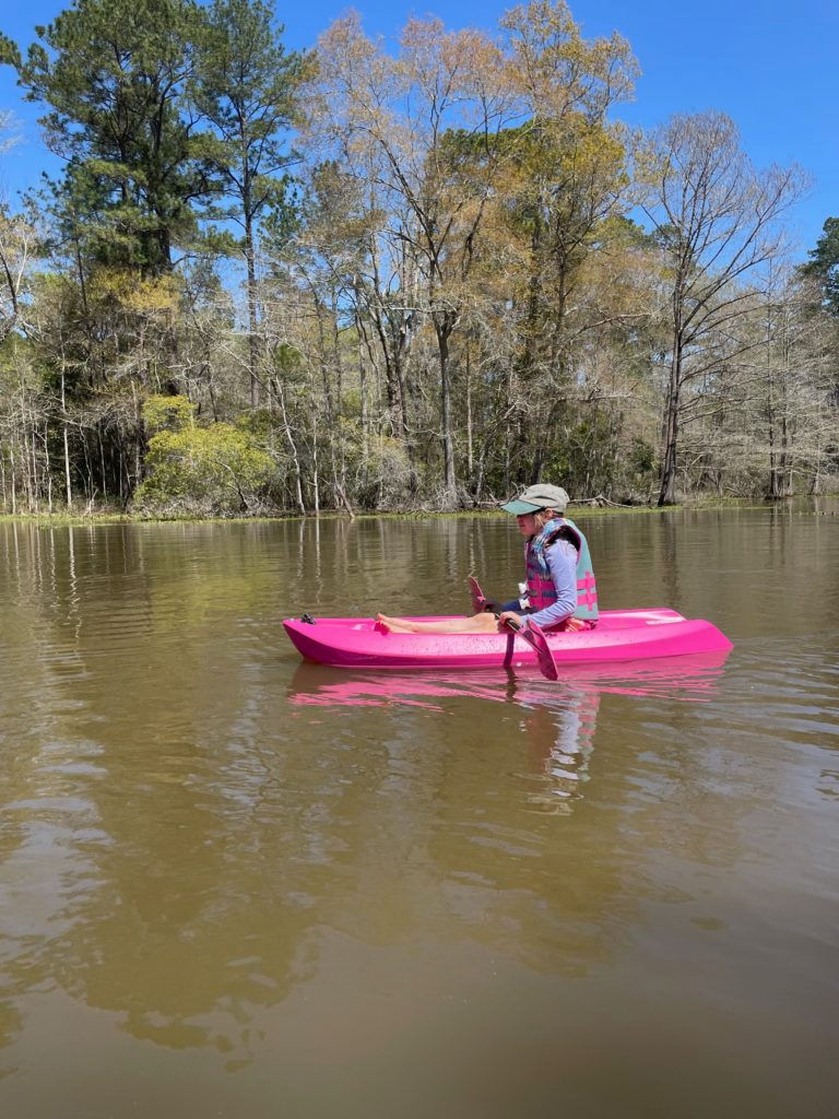 A young girl enjoys a day on the water in one of the best Family-Friendly Paddling Locations in Texas.