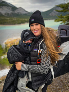 Adrianna wears a satellite messenger while hiking.