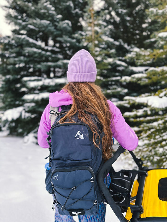 Adrianna wears a Mounts backpack in the snow.