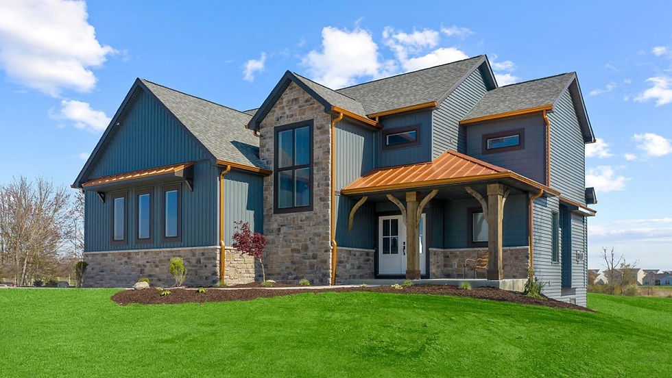 Warm mix of tans, buffs, and soft grays in cut cobblestone, creating a rustic-modern farmhouse look beside bold siding.