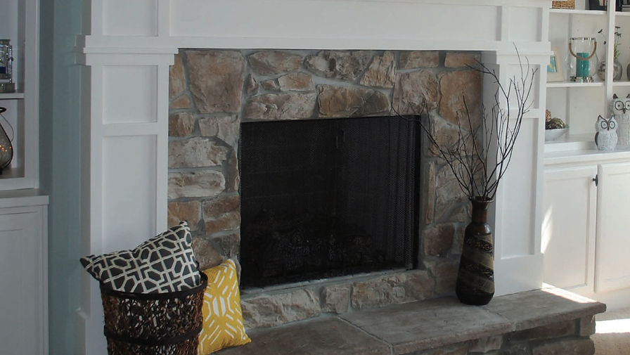 Chunky, irregular stones in warm tans and soft grays give this fireplace a cozy, hearth-like feel with plenty of natural character. It pairs beautifully with white trim for a comfortable, lived-in look.