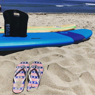 trusii, trusii 6 pack of water bottles on a surfboard