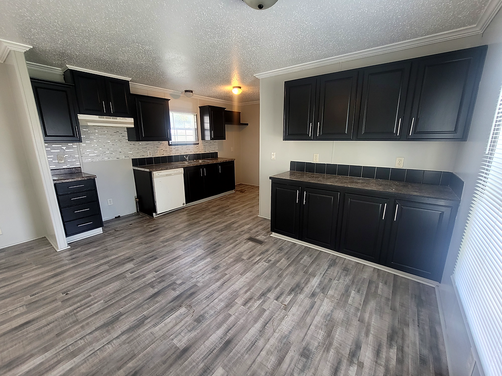 Black cabinets in kitchen with open floor plan
