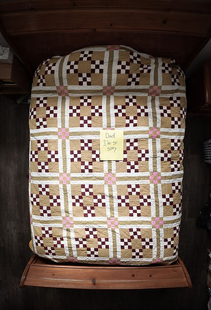 A bed with a note that reads "Dad I'm So Sorry"
