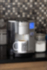 Funny mug with coffee pouring into it from a Cuisineart coffee maker