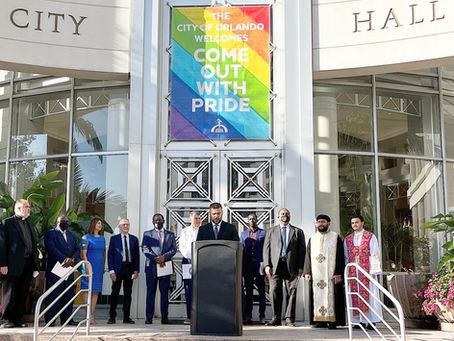 Pastors from multiple Christian denominations standing together in prayer on the steps of Orlando City Hall during a citywide prayer gathering in 2020