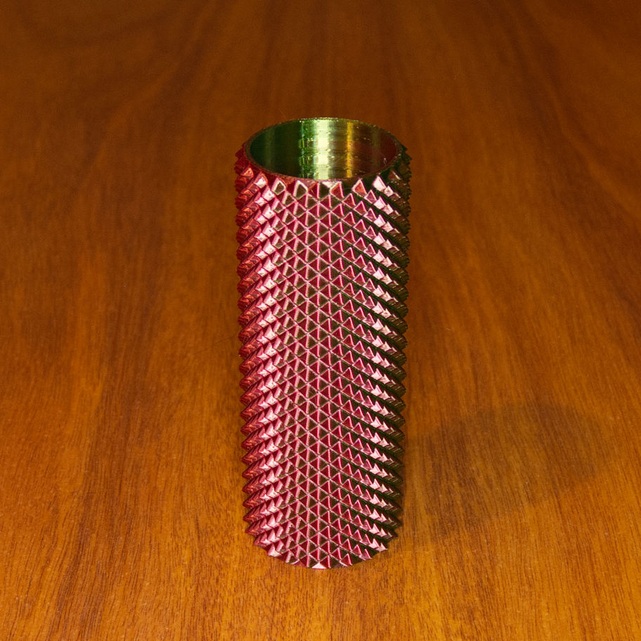Angled Stress Press showing its tall open cylinder and raised dual-point texture.
