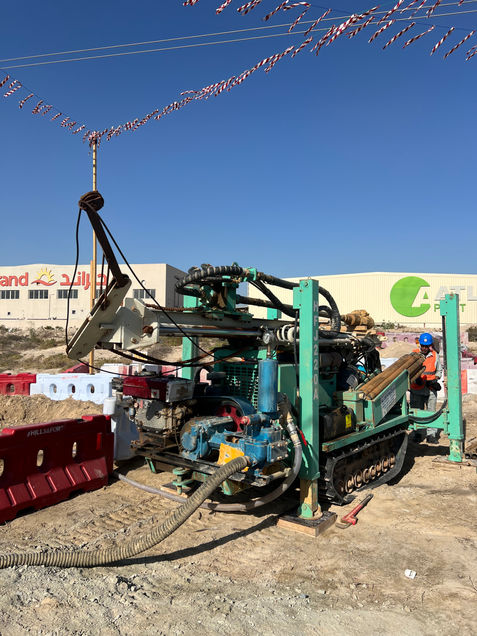Drilling rig for water borewell with worker on site