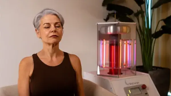 Close up of a patient sitting next to the BioCharger during a session