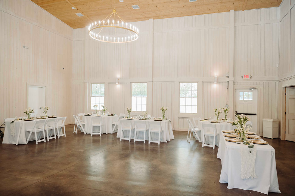 Eye-level view of a rustic barn wedding venue with wooden beams and string lights