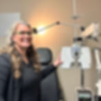 Dr. Deschênes standing beside an ocular examination machine