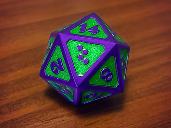 An oversized (25mm) purple metal d20 with raised matte dark purple edges and numbers, recessed faces filled with glittery neon green enamel. Number 20 is the braille letter T like on our braille dice.