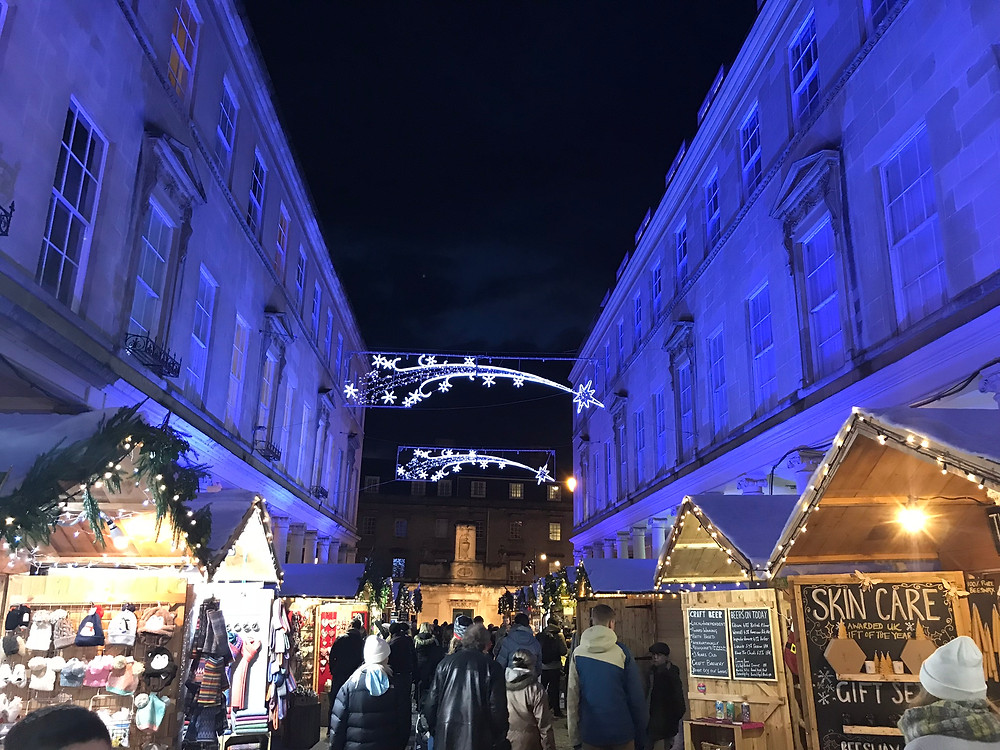 Bath Christmas market at night with blue lights in England