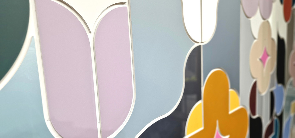 Close-up van kleurrijke, gestileerde bloemvormen op een decoratief paneel, moderne kunst.