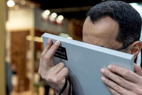 Man inspecteert grijs Forner Soft Touch monsterpaneel nauwkeurig.