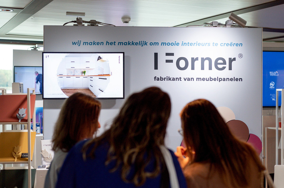 Drie mensen bij I Forner stand, fabrikant meubelpanelen, makkelijke interieurs.