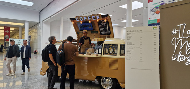 Barista in koffietruck serveert drankjes onder duidelijk COFFEE bord.