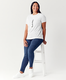 A model sitting on a white stool modeling a custom T-shirt by JAH SOLUTIONS LLC