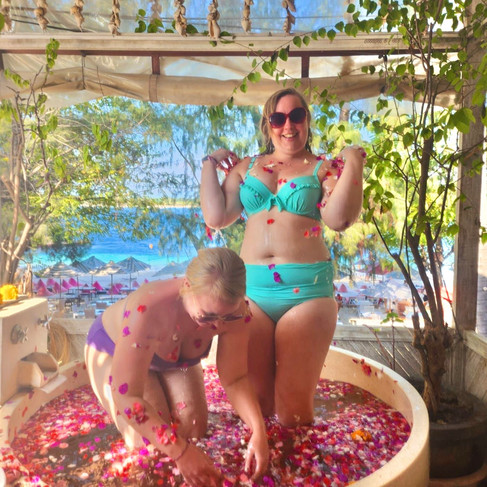 Our Bali Travel Queens having fun in a flower bath on Gili T Island on our Bali Adventure Group Tour Holiday for Women 