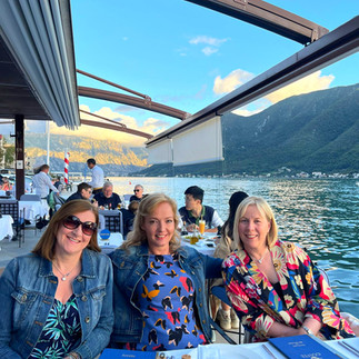 Travel Queens enjoying dinner at our waterfront hotel on the Bay of Kotor, Perast, Montenegro on our women-only group holiday tour Balkan Adventure