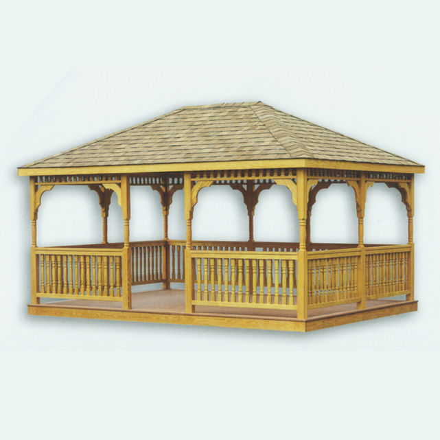 A large rectangular gazebo with turned posts and traditional 2x3 railing system. The structure features a hip-style roof with rustic cedar shingles, decorative Victorian brackets, and a premium teakwood floor. The natural wood elements create a harmonious blend of classic design and modern functionality.


