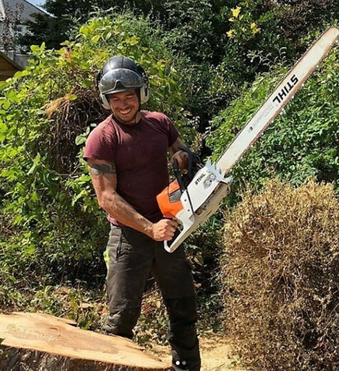 Local tree surgeon, The Tree Man holding a chainsaw