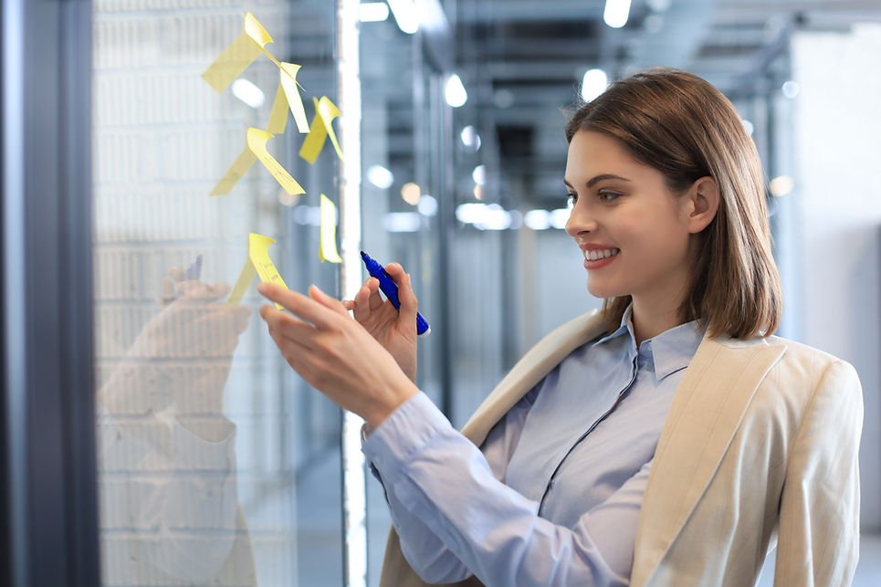 attractive-busness-woman-post-stickers-glass-office-writing-them.jpg