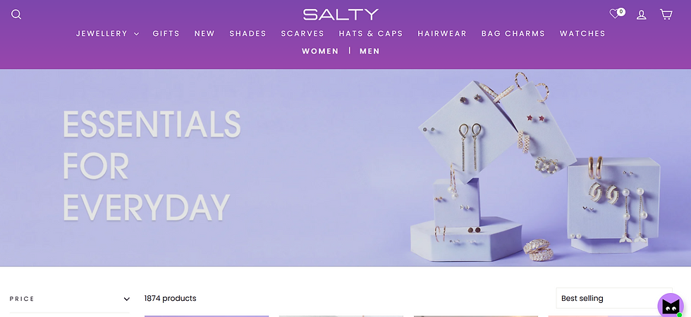 Purple background with jewelry on display blocks. Text reads "ESSENTIALS FOR EVERYDAY." Menu bar with categories like JEWELLERY and GIFTS.