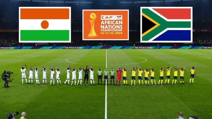 Soccer teams from Niger and South Africa line up on a field with flags above. CAF African Nations Championship 2024 logo displayed.
