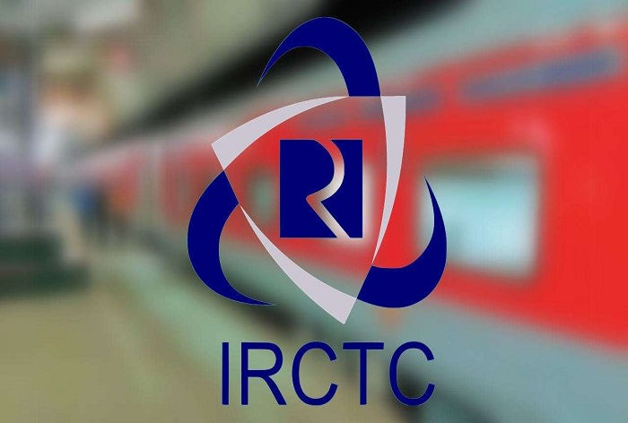 IRCTC logo in blue over a blurred red train background, featuring dynamic swirl design, conveying movement and travel theme.