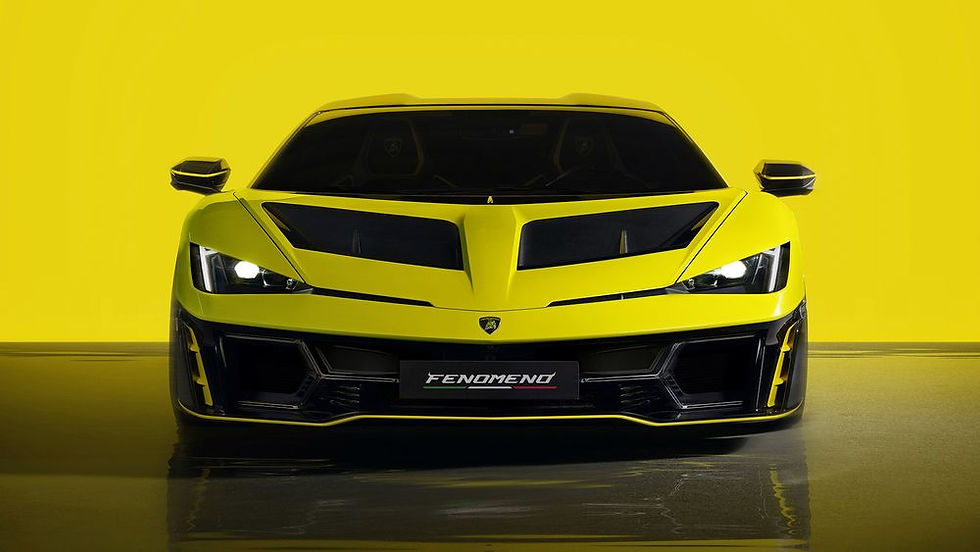 A sleek yellow sports car with sharp lines and bright headlights is set against a matching yellow background. The word "FENOMENO" is on the license plate.