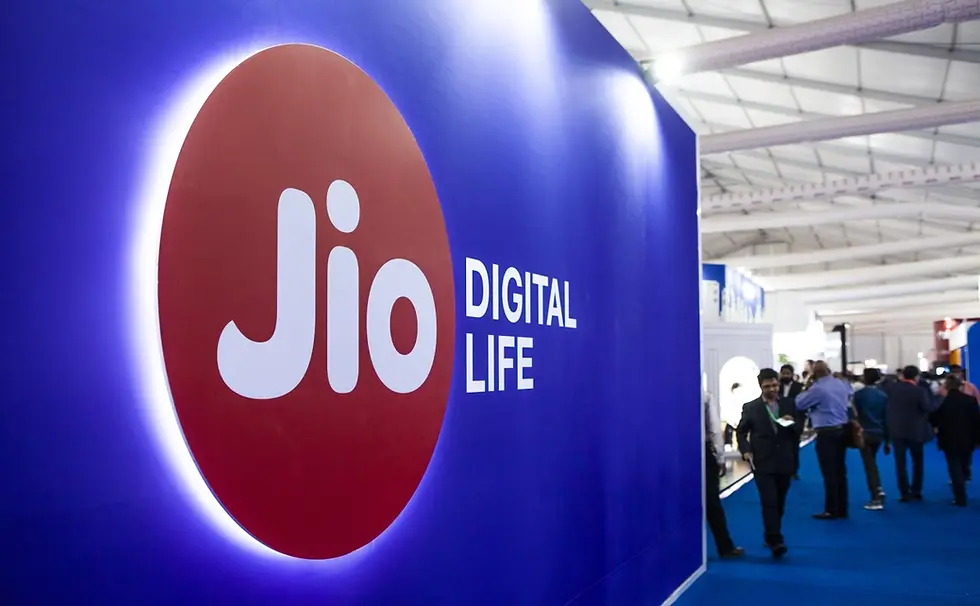 Blue exhibition hall with a prominent Jio Digital Life logo on the left. People walking and interacting in the background.