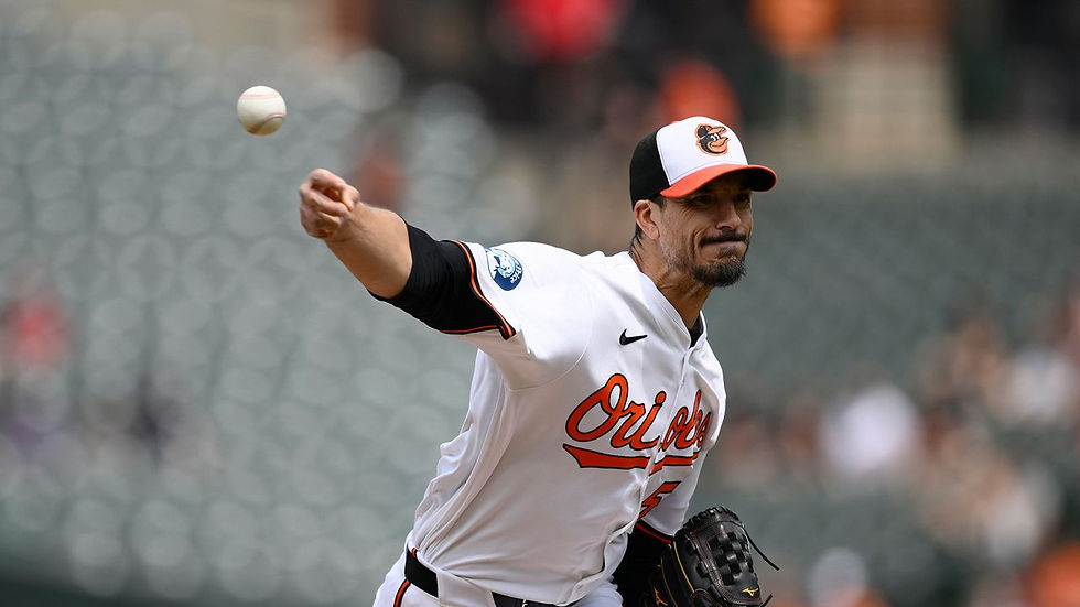 Pitcher in a white "Orioles" jersey throws a baseball on a field. Blurred stadium seating in the background. Focused and intense mood.