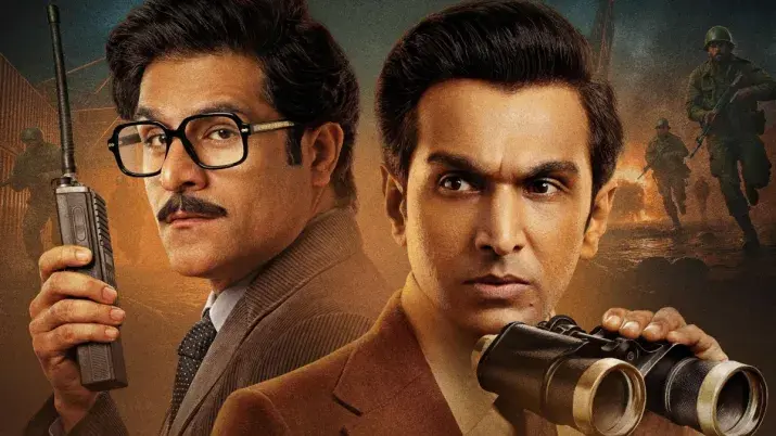 Two men in suits hold a walkie-talkie and binoculars, looking serious. Background shows soldiers near fire. Dramatic and intense mood.