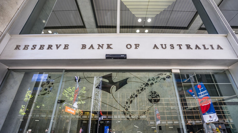 Entrance to Reserve Bank of Australia, showing a glass facade with artwork. Visible reflections and a colorful flag in the background.