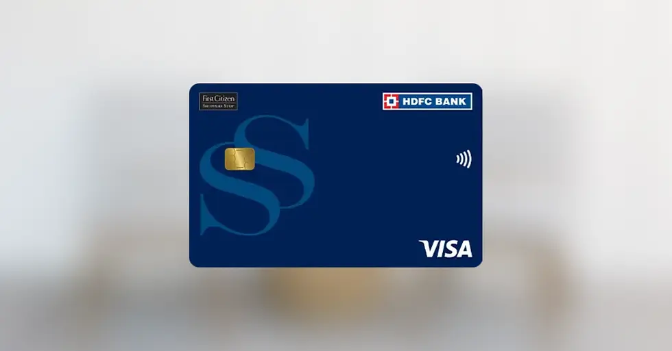 A blue HDFC Bank Visa credit card with a gold chip, wireless symbol, and "First Citizen" text, set against a blurred gray background.