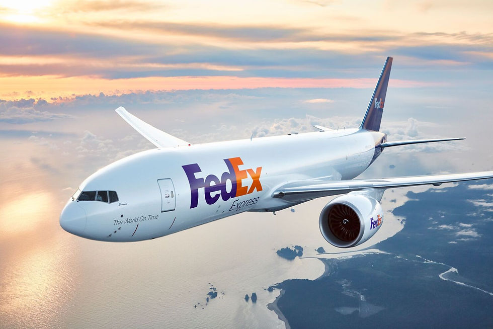FedEx plane flying at sunset over a coastal landscape. White fuselage with bold FedEx logo in purple and orange. Serene sky background.